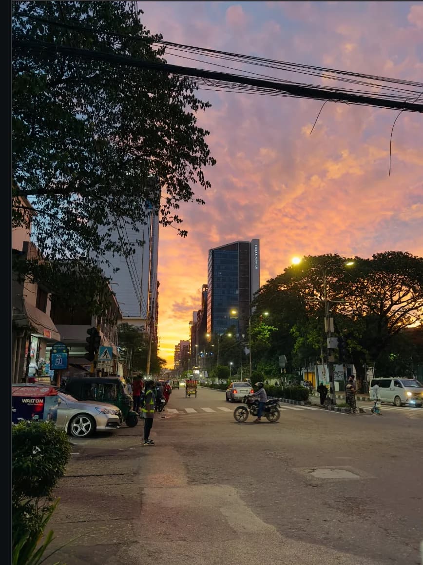 Dramatic sunset over a Dhaka street corner